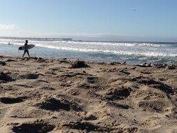 surfer on the beach on a sunny day