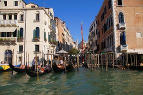 gondolas on a canal in venice in italy