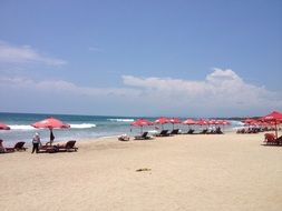 red parasols on a sunny beach in bali