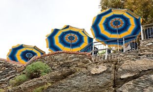 parasols on a stone cliff