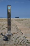 beach shower on seashore boat aback