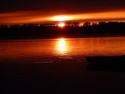 red sunset mirroring on water