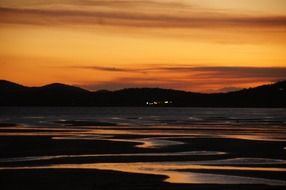 dusk landscape with sunset reflection on water, new zealand