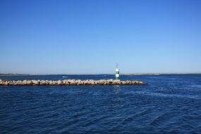 lighthouse on a rock beach