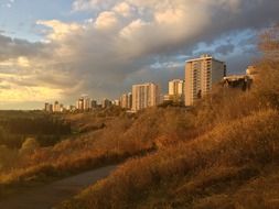 skyline of modern city in river valley at cloudy sunset, canada, edmonton
