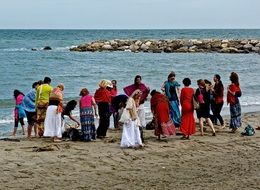 women dance on the beach