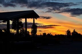 dark silhouettes against the backdrop of an orange sunset