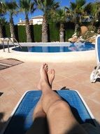 bare feet against the backdrop of the pool