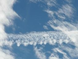 trail from an airplane near the clouds