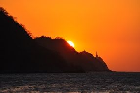 sunset over the mountains on the coast of colombia