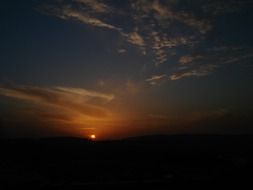 sun beyond the horizon at sunset