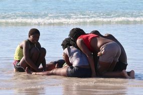 children on the wet sand on the beach