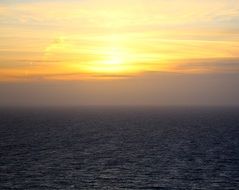 golden sunset and fog over the sea