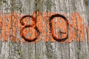 number "80" on an old wooden surface