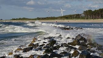 stone shore of the sea and the windmills