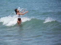 children splashing in waves