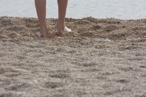 beautiful feet in the sand on the beach