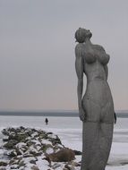 mermaid sculpture in snowy winter, baltic sea