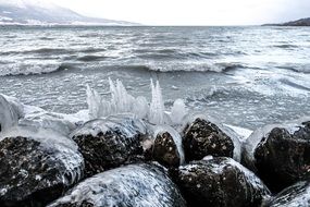 beautiful beach of mountain lake at winter, switzerland