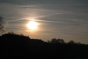 sunset over the silhouette of the hills