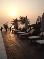 white deck chairs at sunset