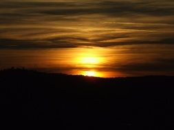 the sun has gone beyond the horizon of the hills