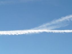 white trail from an airplane in the sky