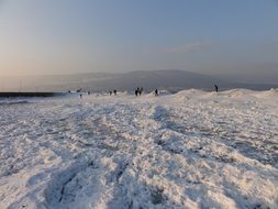 people on a frozen lake