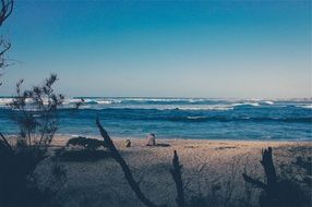 sea with waves and man on the beach