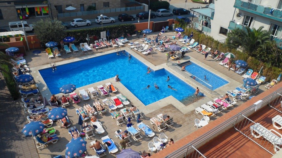 people near blue water pool