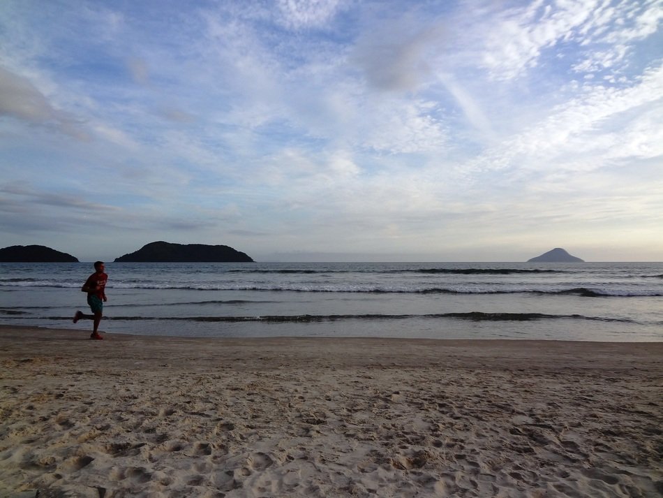 man runs on the beach