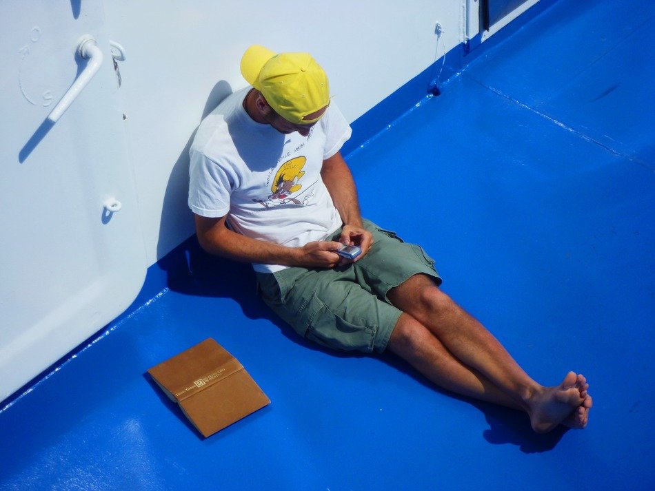man sitting on the blue deck
