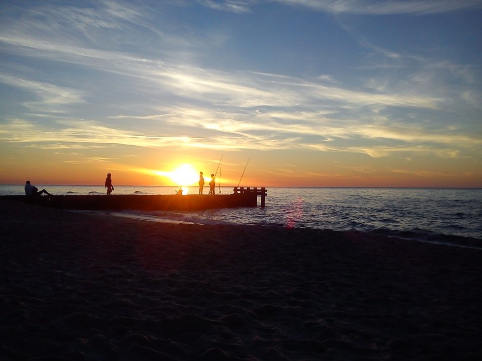 pier on beach sea sunset