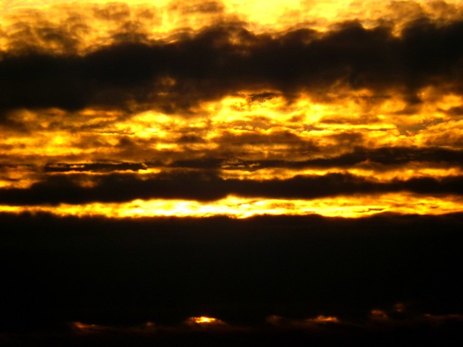 yellow sunset in dark clouds close-up
