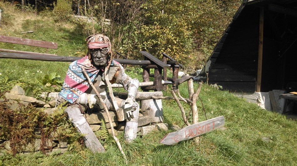 man sits on wooden beams in poland