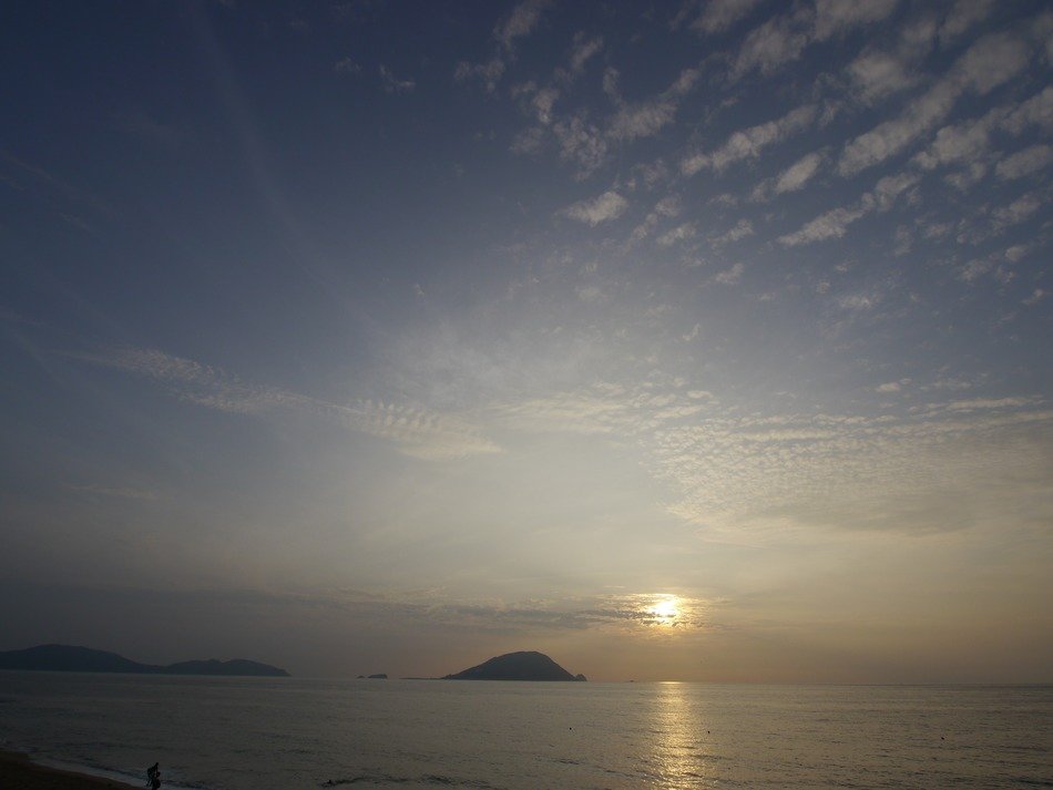 small island in the background of the sea sunset