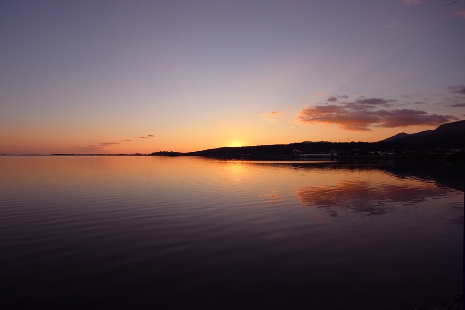 sunset over the hills near the sea