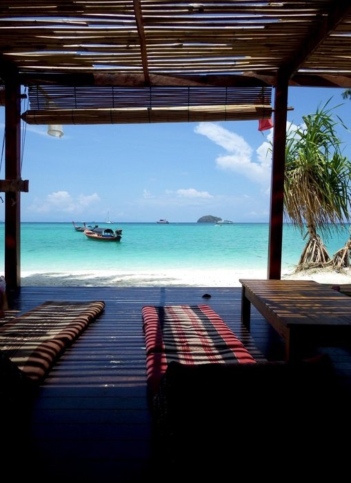 distant view of a boat on the water on a paradise beach