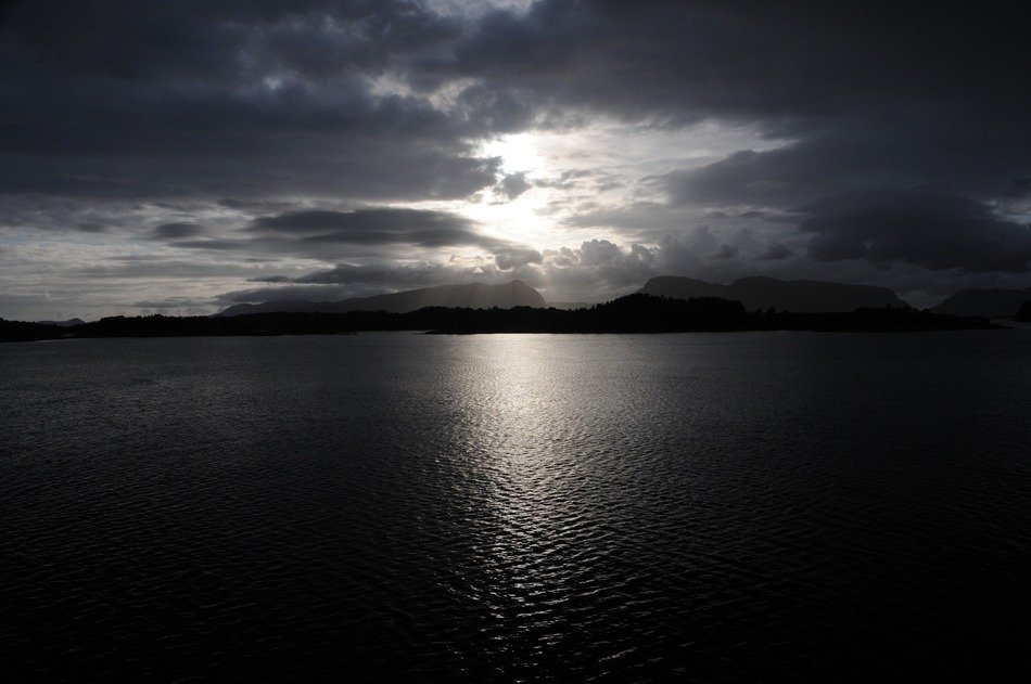 black and white photo of sunset in norway