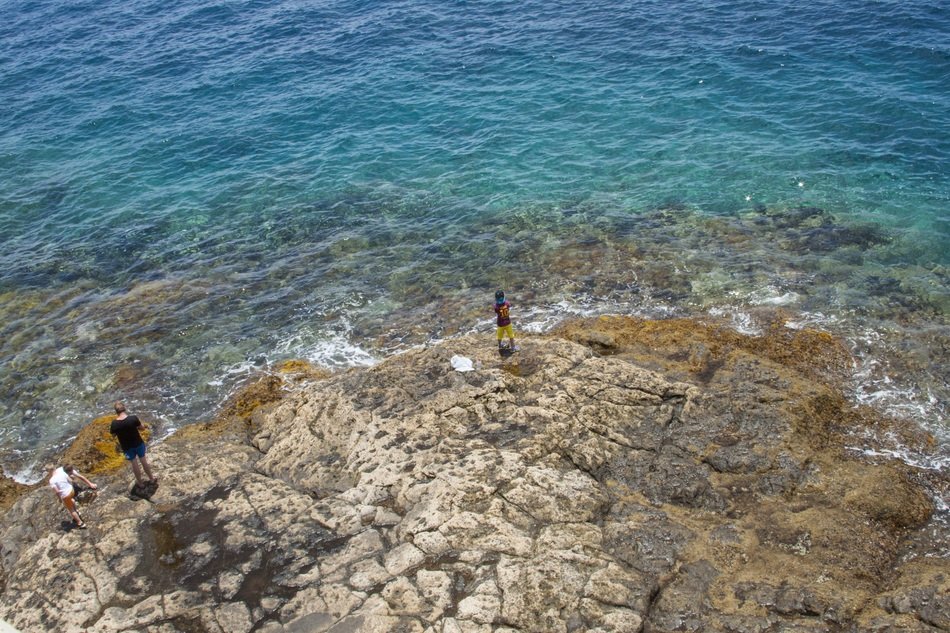 children on the rocky coast