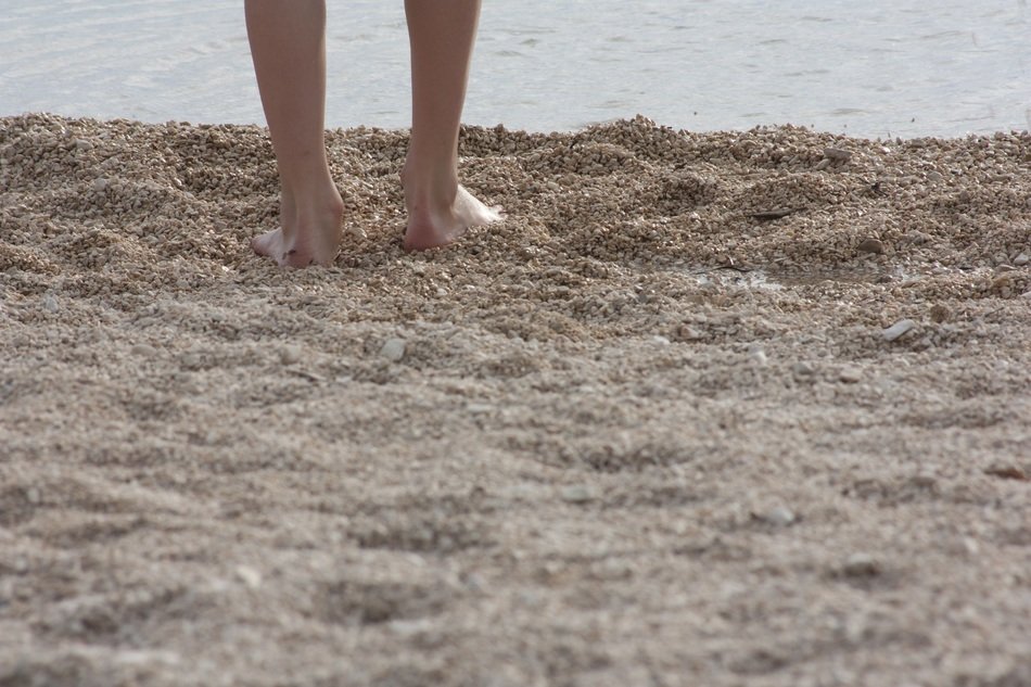 beautiful feet in the sand on the beach