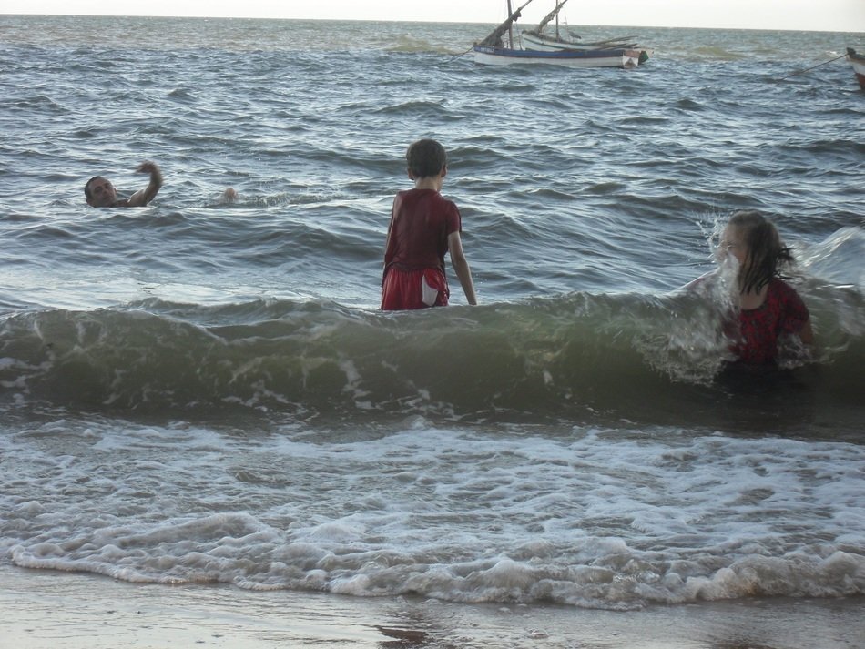 happy kids in the surf of the ocean
