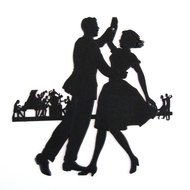 black silhouette of a dancing couple on stage