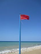 warning red flag on the beach