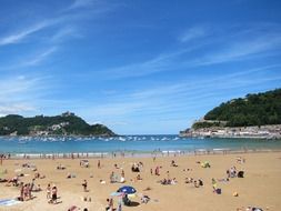 people on a sunny beach in San Sebastian