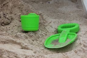green toys in the sand