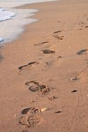 footprints on the beach sand