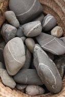 stones in a basket on the beach