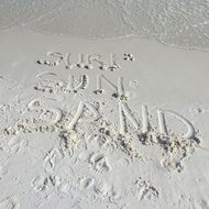 inscription surf, sun and sand on the beach