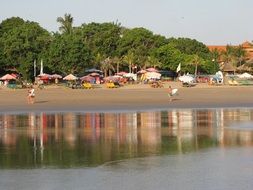 sandy beach with people, indonesia